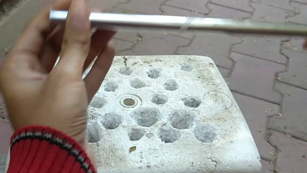 Use a hollow metal rod to create the holes